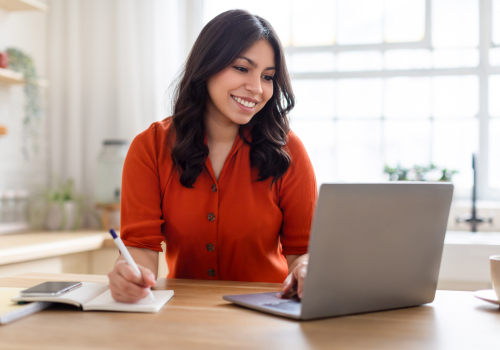 Vrouw volgt een online training achter haar laptop